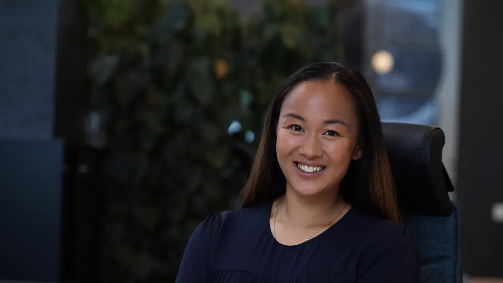Asian girl looking in to the camera in a dark environment at an office