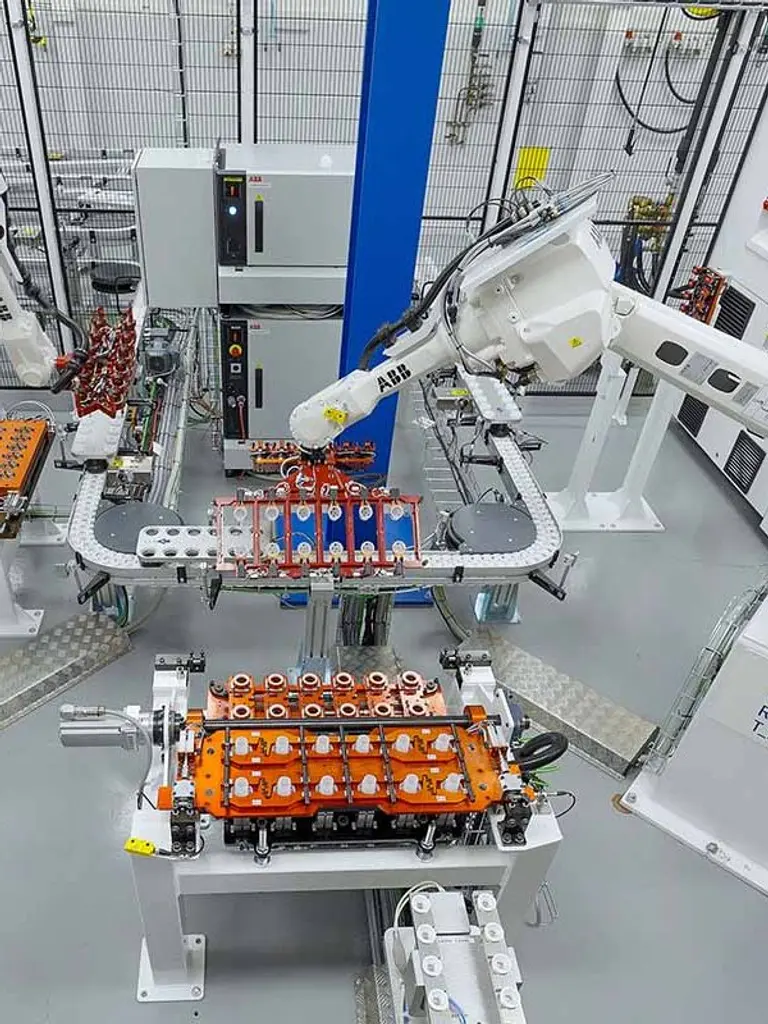 Two robots working at Rosti Sweden