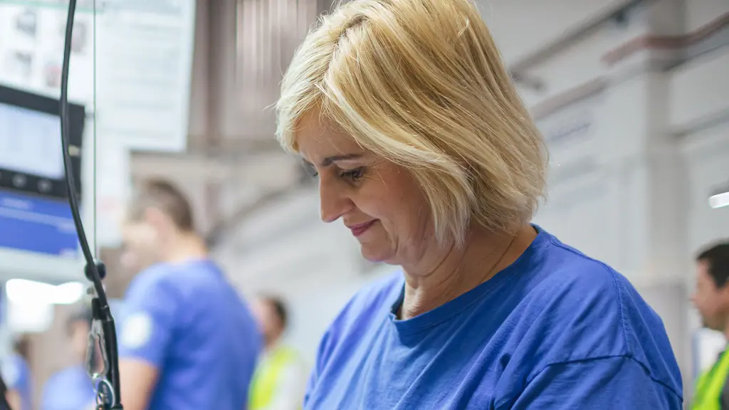 Blond female Rosti staff working with assemblying stuff.