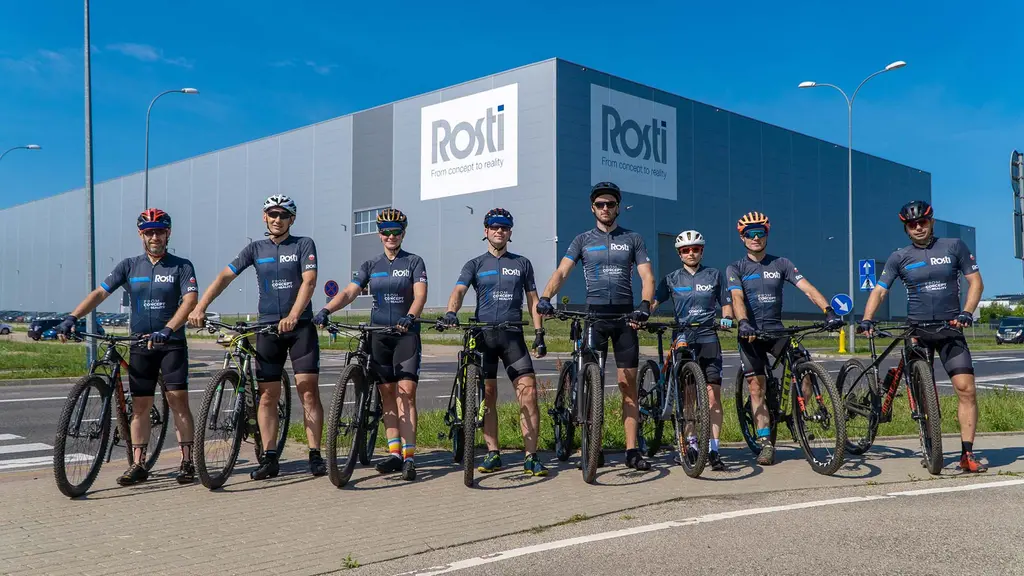 10 people on bikes in and Rosti-labelled clothes