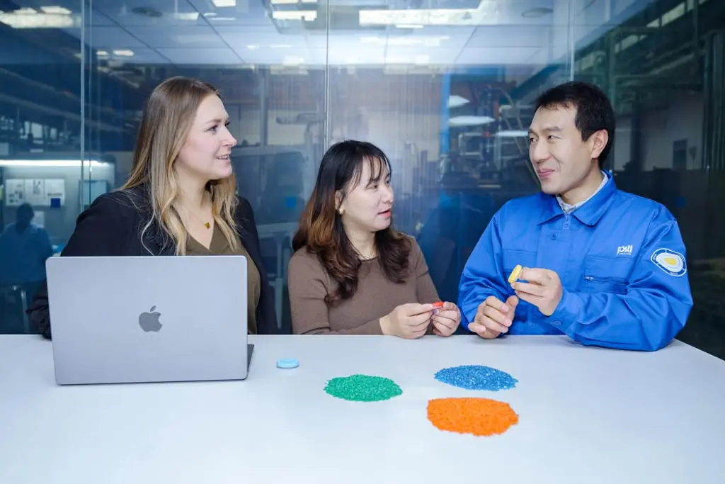 three staff talking about material
