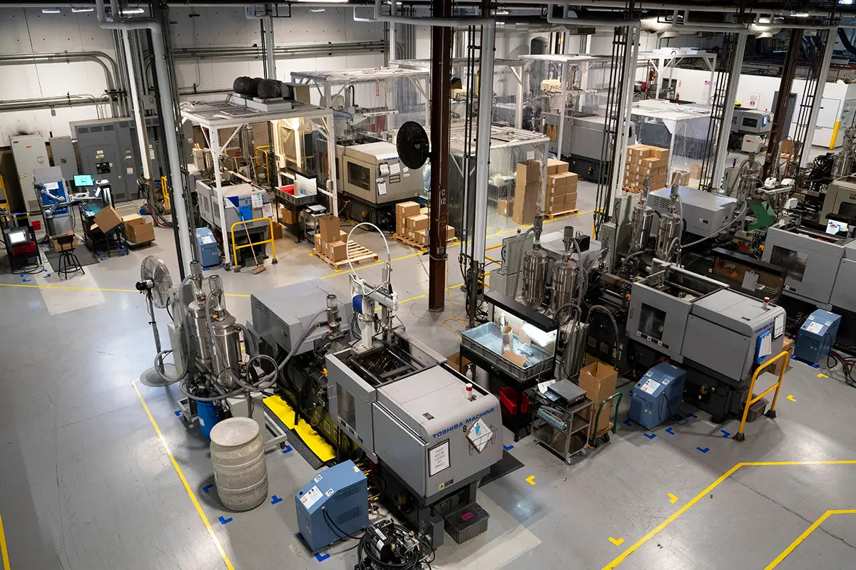 a workshop with plastic injection molding machines in Rosti Utah