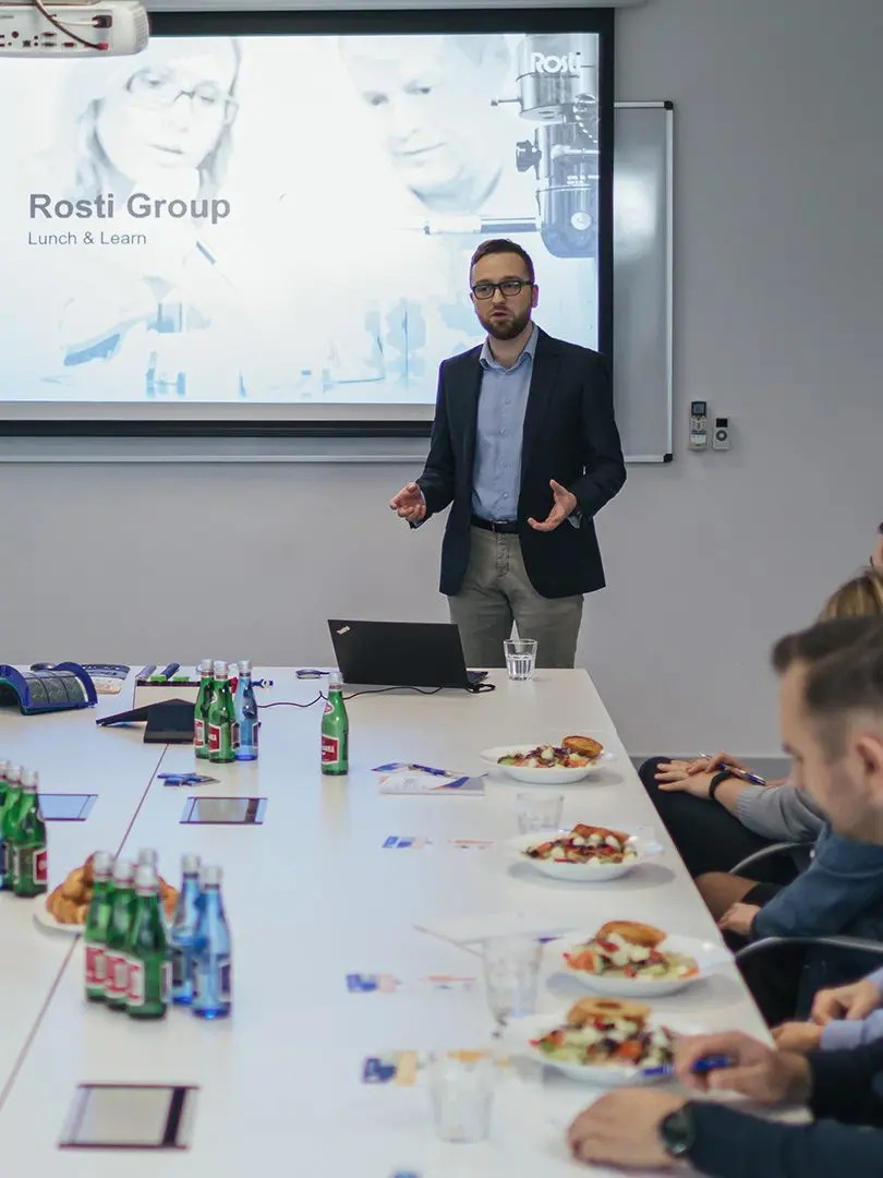 people eating lunch and learning about Rostis Plastic Injection Moulding.
