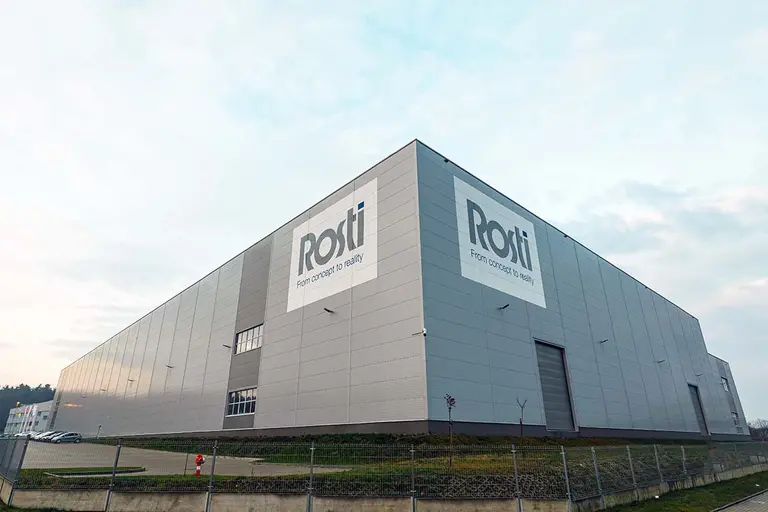 Big Building from an angle with a large sign Rosti