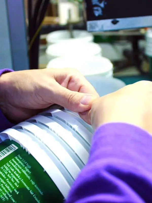 Hands working with the automated process.