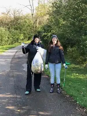 Rosti employees hold garbage bags after a river clean up in Menomonee Falls