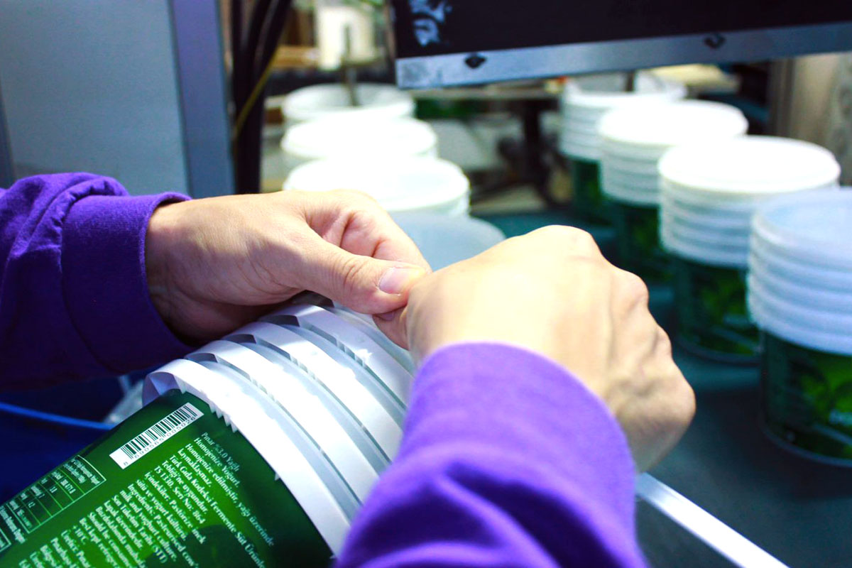 Hands working with the automated process.