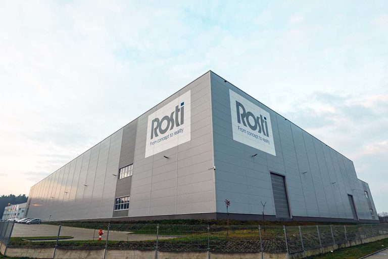 Big Building from an angle with a large sign Rosti