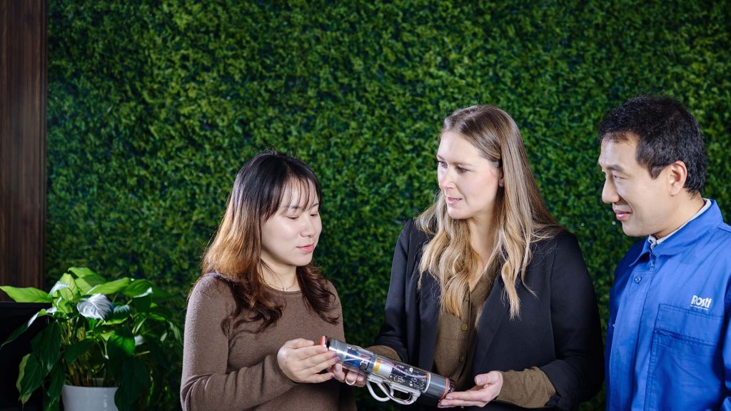 three people discussing electric product