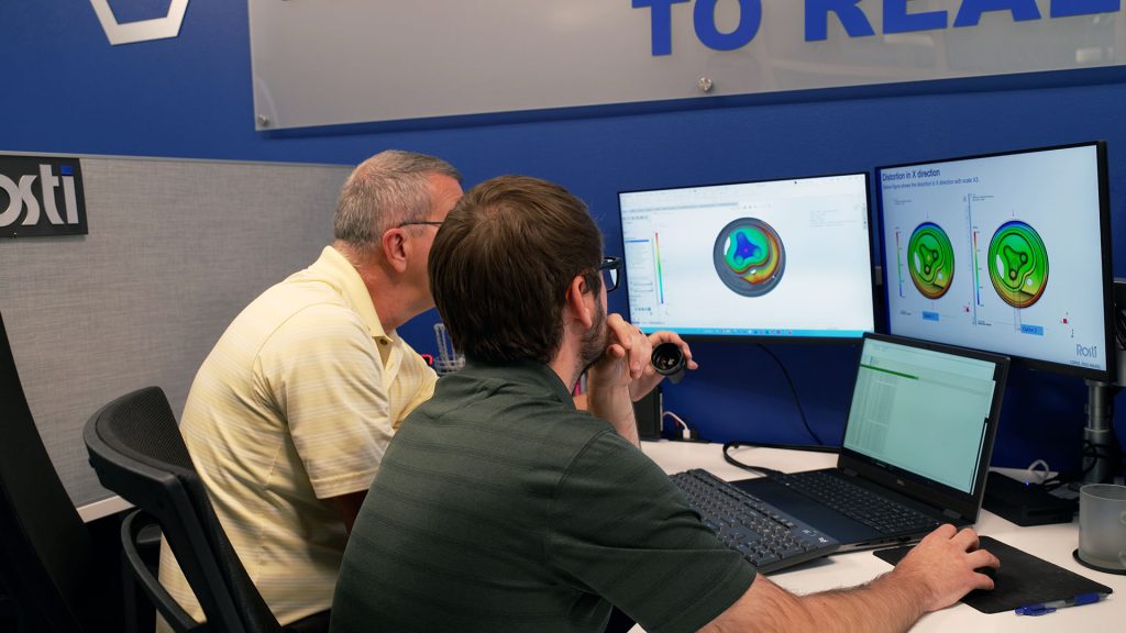 two enginneers simulate a plastic injection molding process